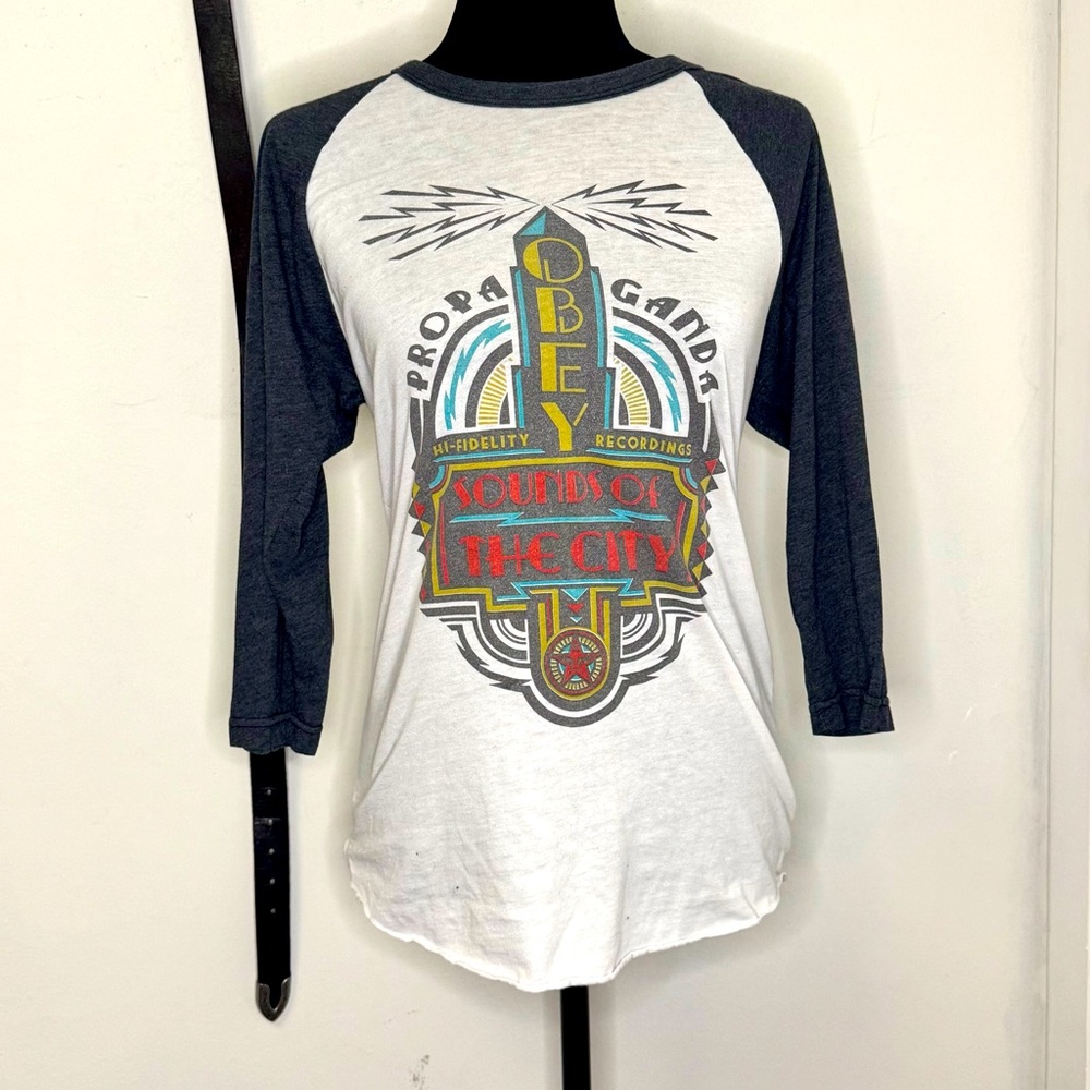 Obey Women's White and Navy Raglan 'Sounds of the City' Graphic Tee